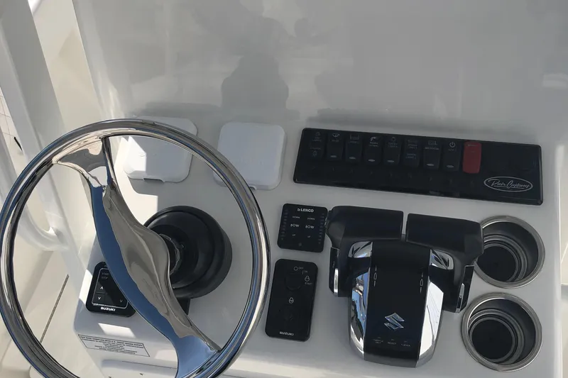 Slide: The Image of Steering console of 2026 Pair Customs 24 Center Console DV boat with controls and switches. - 42