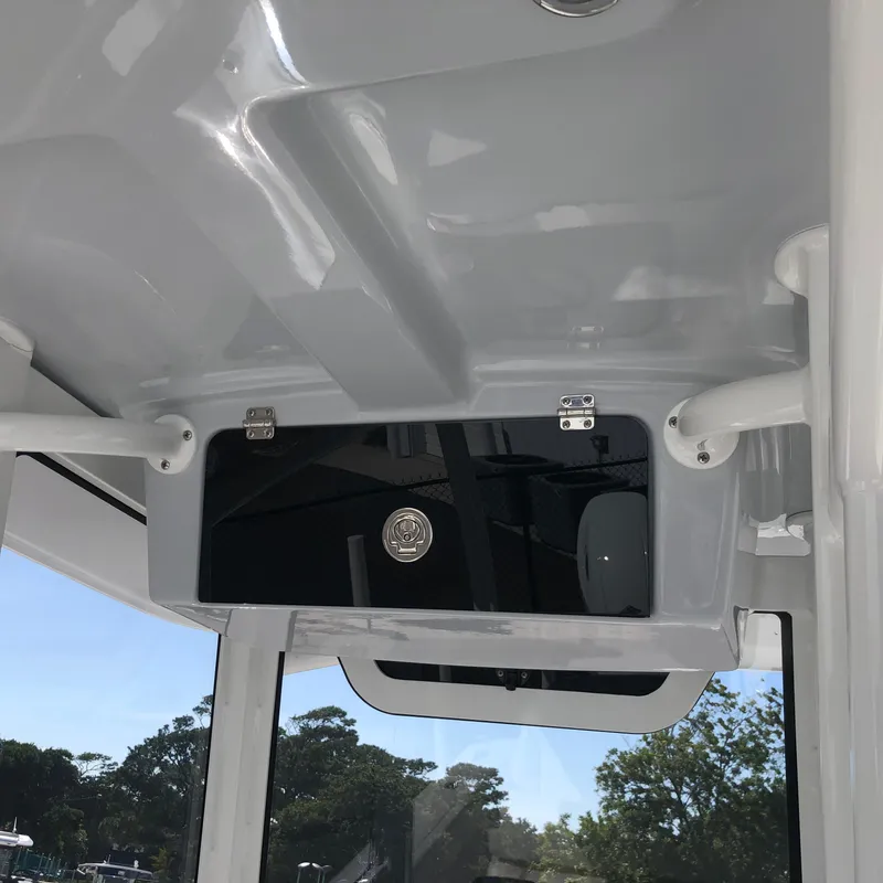 Slide: The Image of Interior view of 2026 Pair Customs 24 Center Console DV boat, featuring sleek design and storage compartment. - 5