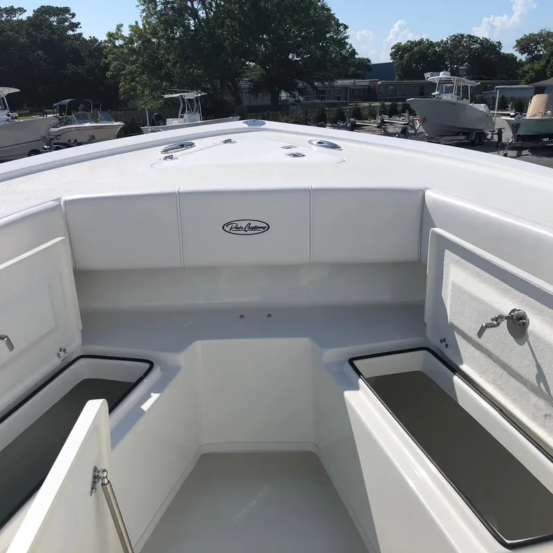 Slide: The Image of 2026 Pair Customs 24 Center Console DV boat interior with storage compartments. - 8