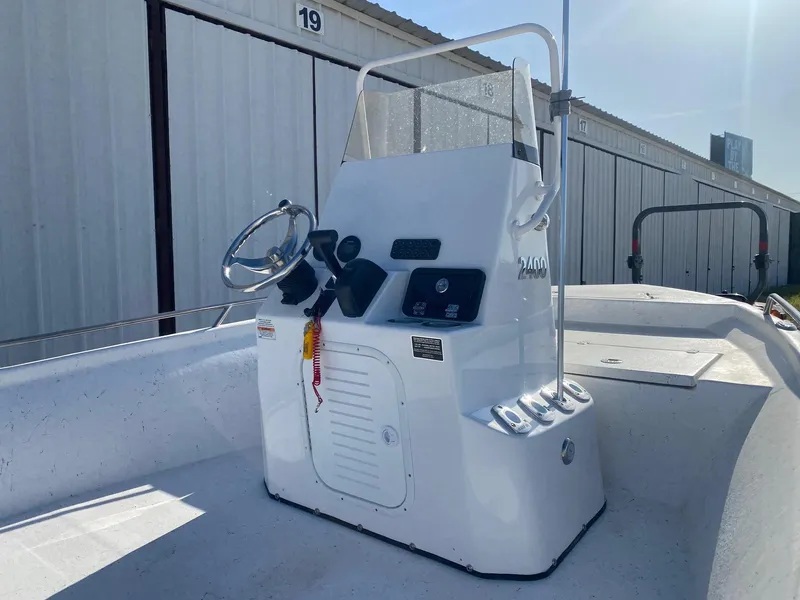 Slide: The Image of 2025 Blazer Bay 2400 Open Bay Striper boat console, featuring steering wheel and controls. - 7