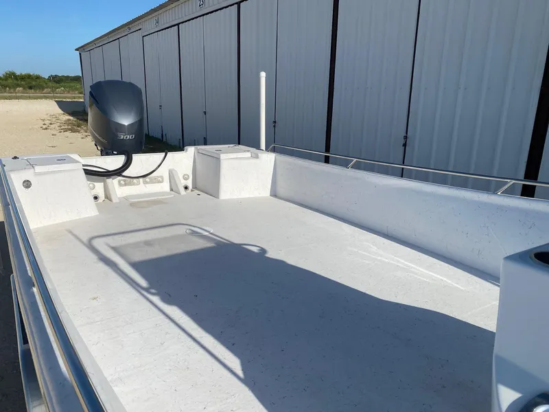 Slide: The Image of 2025 Blazer Bay 2400 Open Bay Striper boat with powerful engine, docked outdoors. - 8