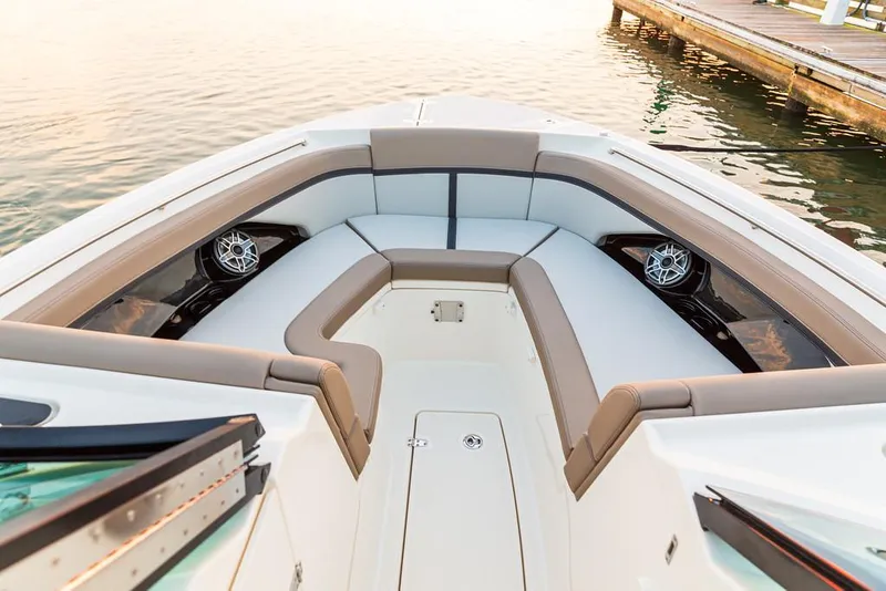 Slide: The Image of Manufacturer Provided Image: 2025 Boston Whaler 330 Vantage boat interior with cushioned seating and speakers. - 2