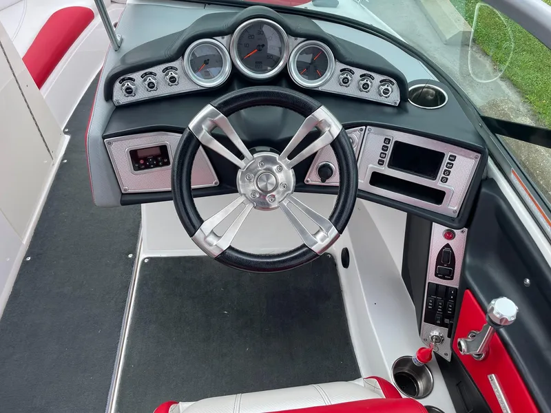 Slide: The Image of 2013 MasterCraft X-14V boat dashboard with steering wheel and control panel. - 3