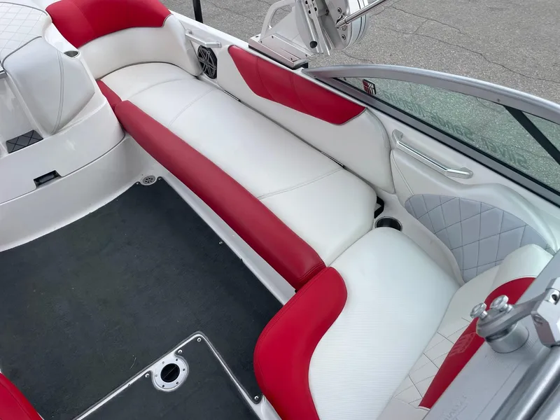 Slide: The Image of 2013 MasterCraft X-14V boat interior with red and white seating, featuring cup holders and speaker. - 6