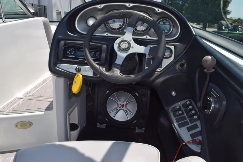 Slide: The Image of 2008 Centurion Elite V C4 Air Warrior boat dashboard with steering wheel and controls. - 12