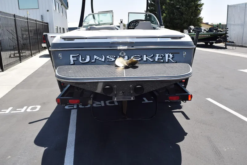 Slide: The Image of 2008 Centurion Elite V C4 Air Warrior boat, rear view, parked in a lot. - 6