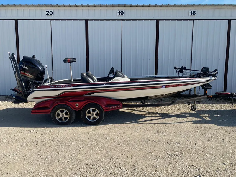 The Image of 2012 Skeeter FX 20 bass boat with Yamaha engine, parked on a trailer. - 0