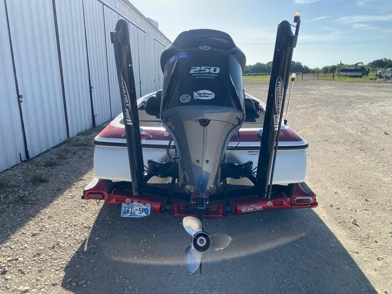 Slide: The Image of 2012 Skeeter FX 20 boat with powerful outboard motor, parked outdoors. - 4