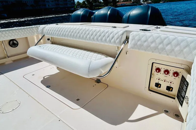 Slide: The Image of 2012 Grady-White Canyon 366 boat with cushioned seating and control panel. - 10