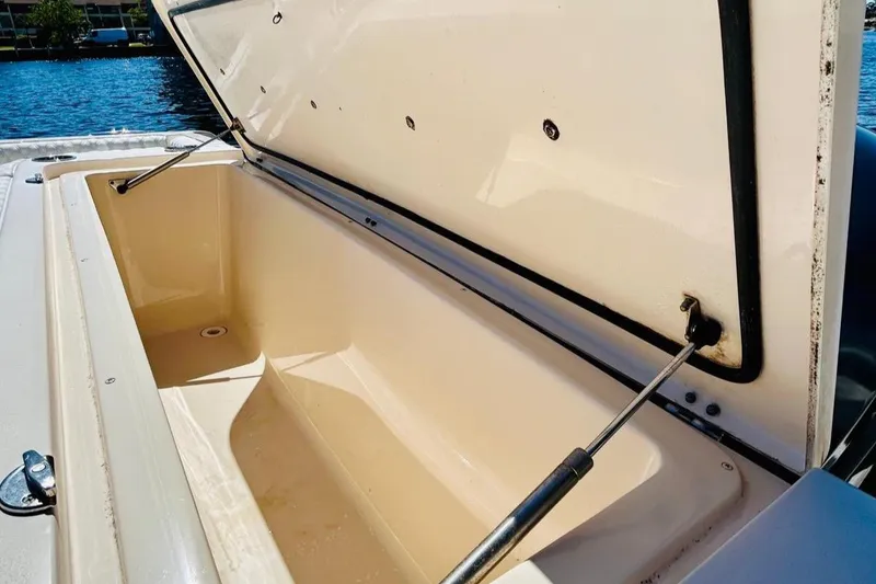 Slide: The Image of 2012 Grady-White Canyon 366 storage compartment open by the water. - 12