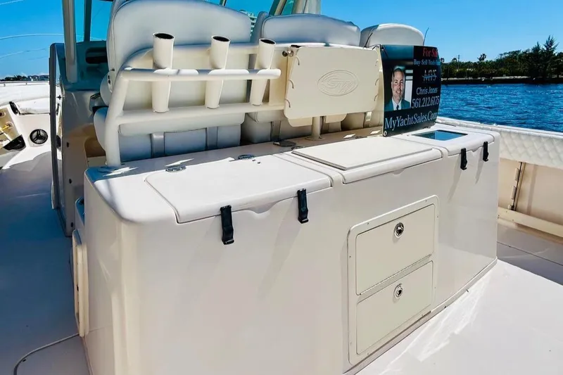 Slide: The Image of 2012 Grady-White Canyon 366 boat interior with storage compartments and rod holders. - 14