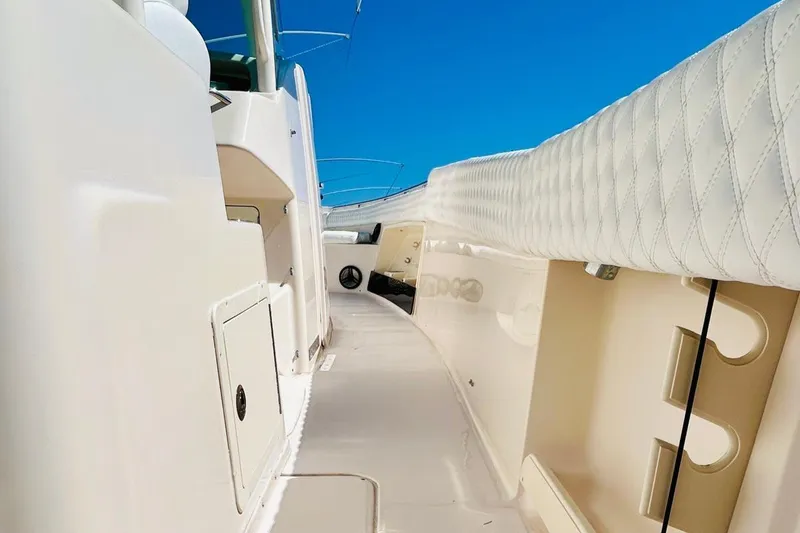 Slide: The Image of 2012 Grady-White Canyon 366 boat interior with white upholstery and storage compartments. - 20