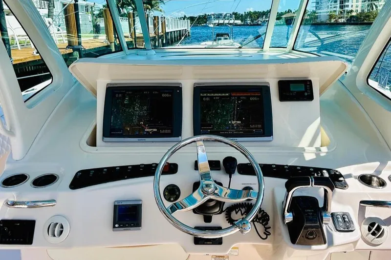 Slide: The Image of Grady-White Canyon 366 2012 boat helm with dual navigation screens and controls. - 24