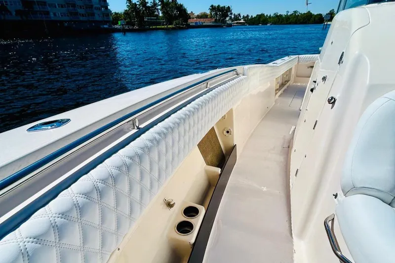 Slide: The Image of 2012 Grady-White Canyon 366 boat interior with white upholstery, on a sunny day by the water. - 31