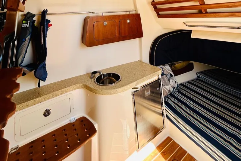 Slide: The Image of Interior of 2012 Grady-White Canyon 366 boat with kitchenette and seating area. - 41