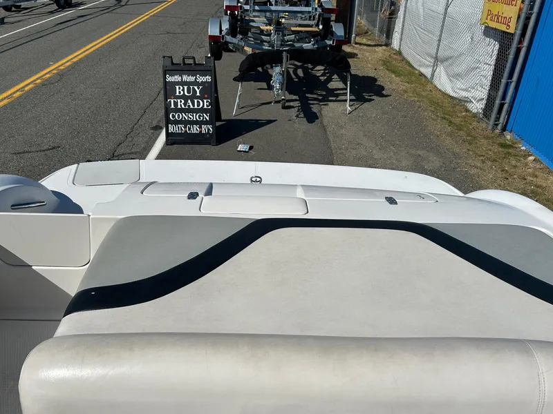 Slide: The Image of 2007 Reinell 220 LSE boat interior with a sign for buying and trading boats. - 12