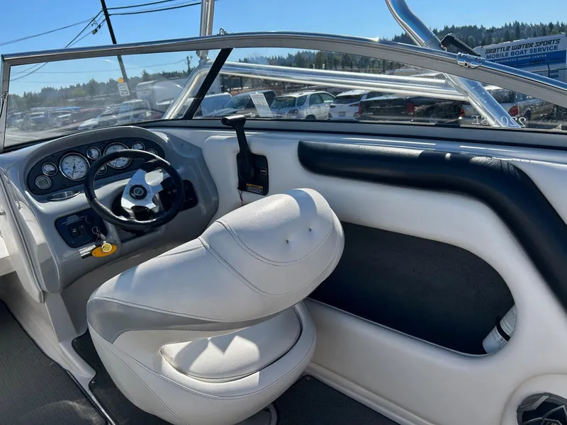Slide: The Image of 2007 Reinell 220 LSE boat interior with steering wheel and white seating. - 15