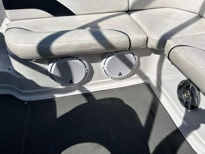 Slide: The Image of 2007 Reinell 220 LSE boat interior with cushioned seating and built-in speakers. - 16