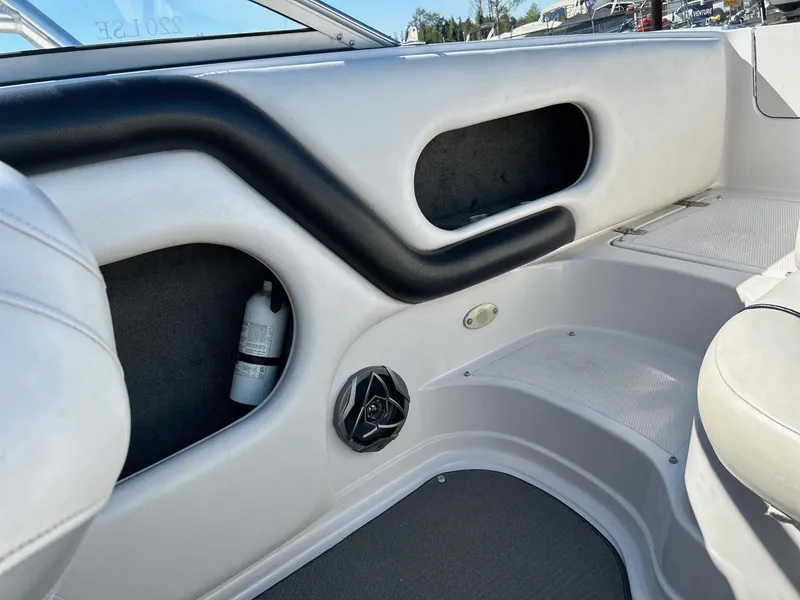 Slide: The Image of Interior of a 2007 Reinell 220 LSE boat, featuring seating and storage compartments. - 17