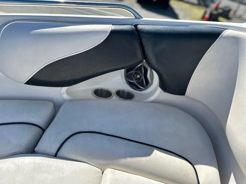 Slide: The Image of Interior of a 2007 Reinell 220 LSE boat, featuring stylish seating and speaker system. - 18