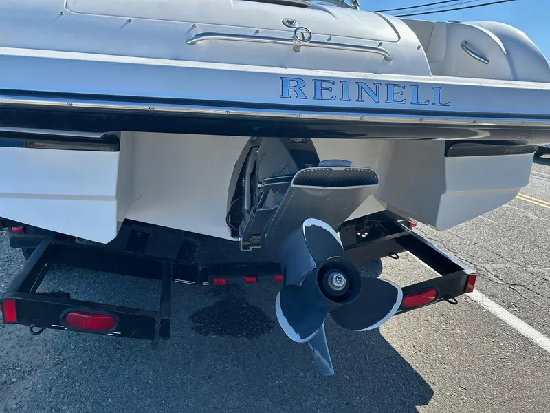 Slide: The Image of Rear view of a 2007 Reinell 220 LSE boat with visible propeller and trailer. - 4