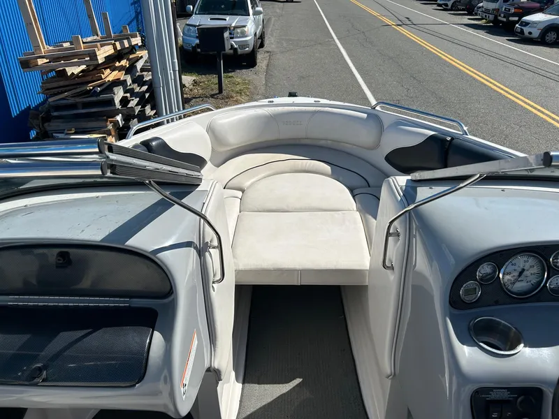 Slide: The Image of 2007 Reinell 220 LSE boat interior with white seating and dashboard view. - 6