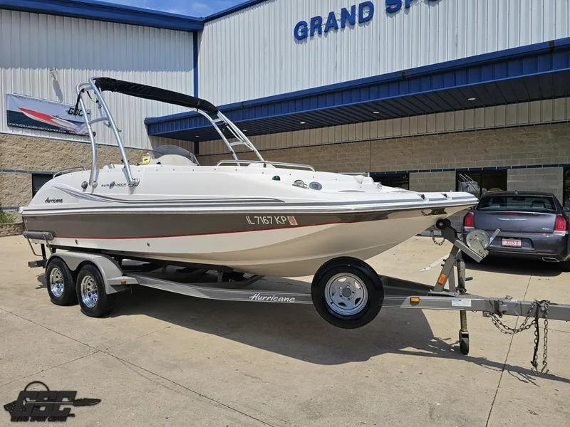 Slide: The Image of 2013 Hurricane SunDeck Sport 202 IO boat on trailer outside dealership. - 11