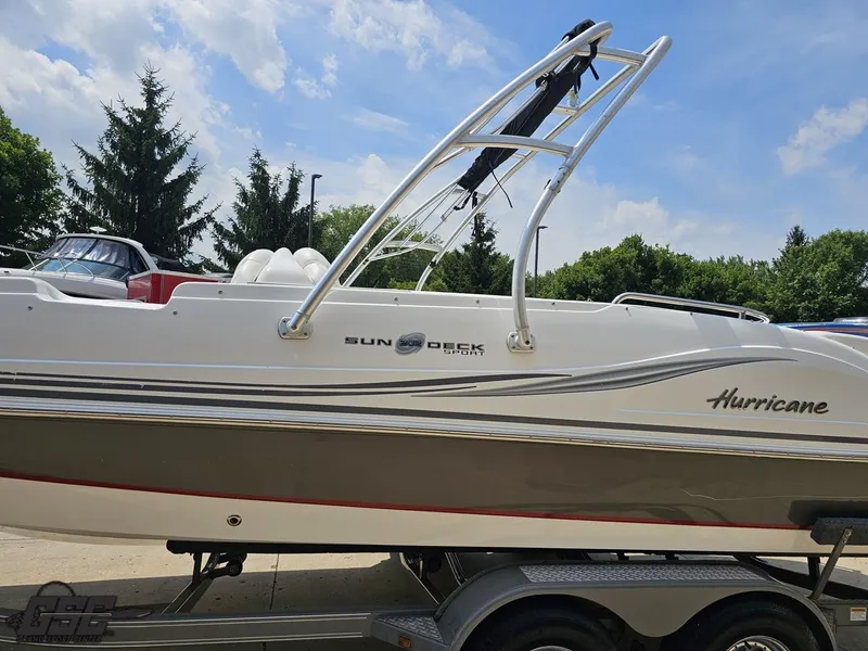 Slide: The Image of 2013 Hurricane SunDeck Sport 202 IO boat on trailer, side view, outdoors. - 19