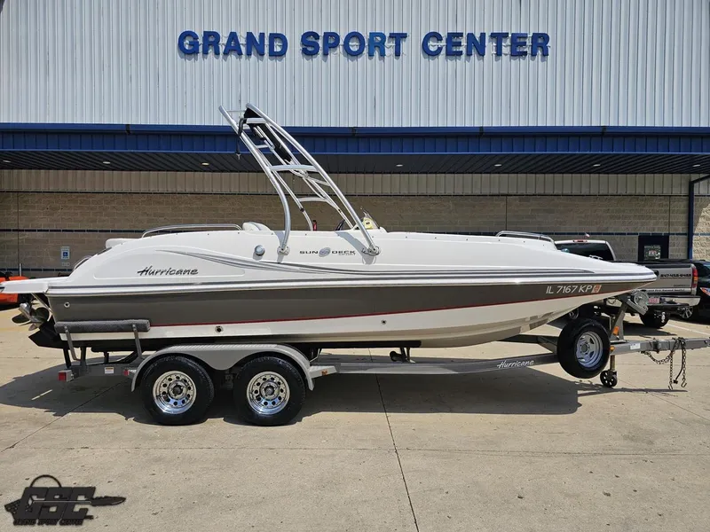 Slide: The Image of 2013 Hurricane SunDeck Sport 202 IO boat on trailer at Grand Sport Center. - 2