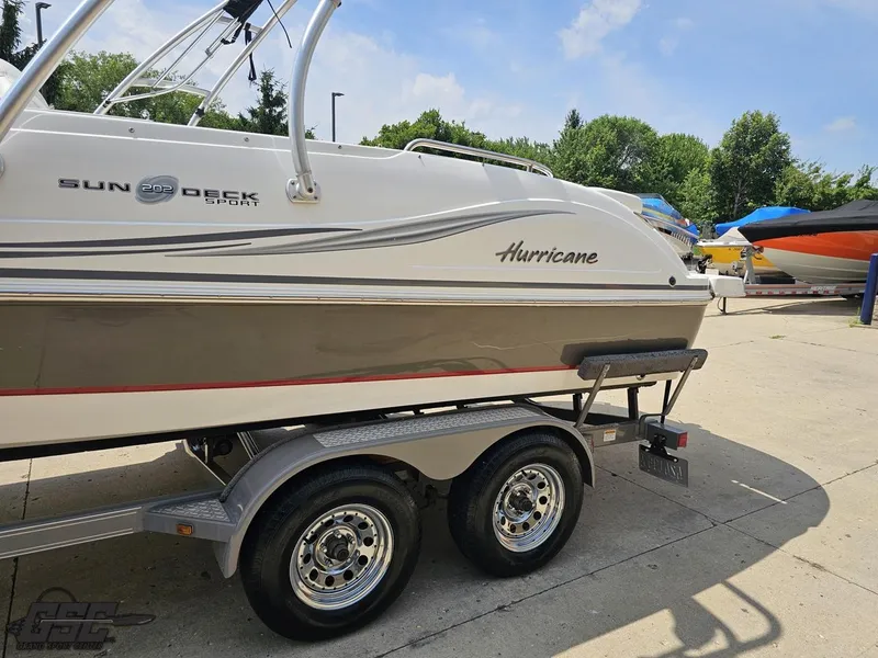Slide: The Image of 2013 Hurricane SunDeck Sport 202 IO boat on trailer, parked outdoors. - 20