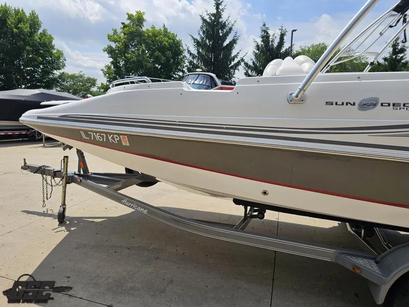 Slide: The Image of 2013 Hurricane SunDeck Sport 202 IO boat on trailer, parked outdoors. - 21