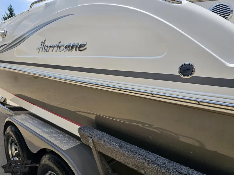 Slide: The Image of 2013 Hurricane SunDeck Sport 202 IO boat on trailer, side view. - 25