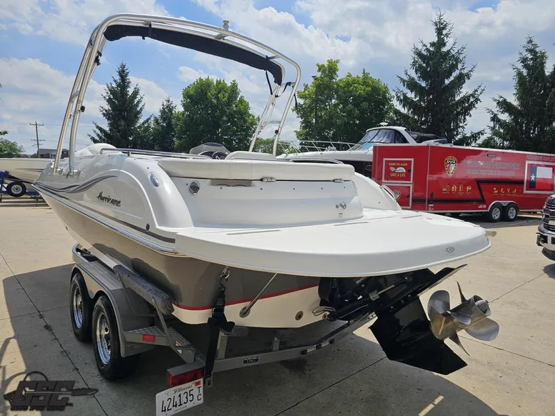 Slide: The Image of 2013 Hurricane SunDeck Sport 202 IO boat on trailer, outdoor setting. - 28