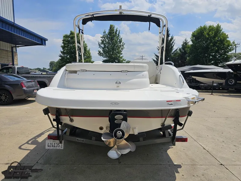 Slide: The Image of 2013 Hurricane SunDeck Sport 202 IO boat, rear view, parked outdoors on a sunny day. - 29