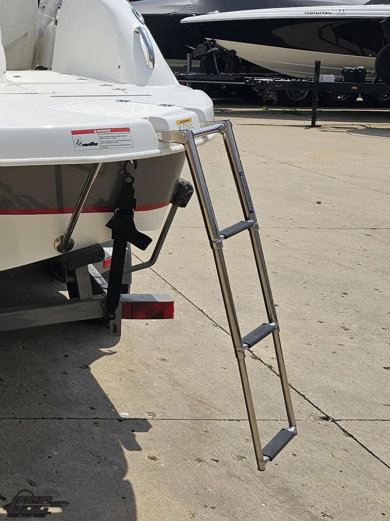 Slide: The Image of 2013 Hurricane SunDeck Sport 202 IO boat with extended swim ladder on trailer. - 30