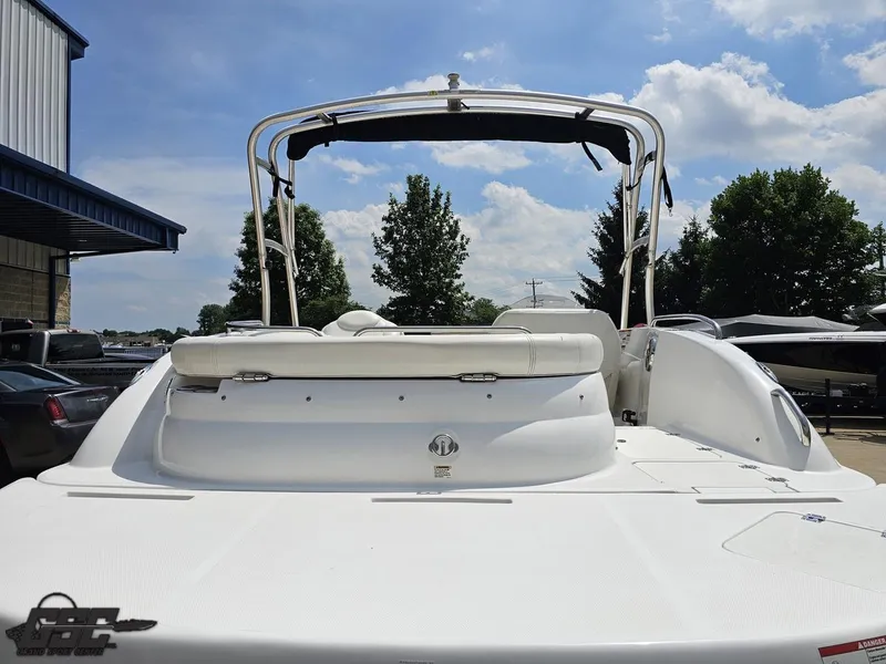 Slide: The Image of 2013 Hurricane SunDeck Sport 202 IO boat, rear view, parked outdoors under a sunny sky. - 34