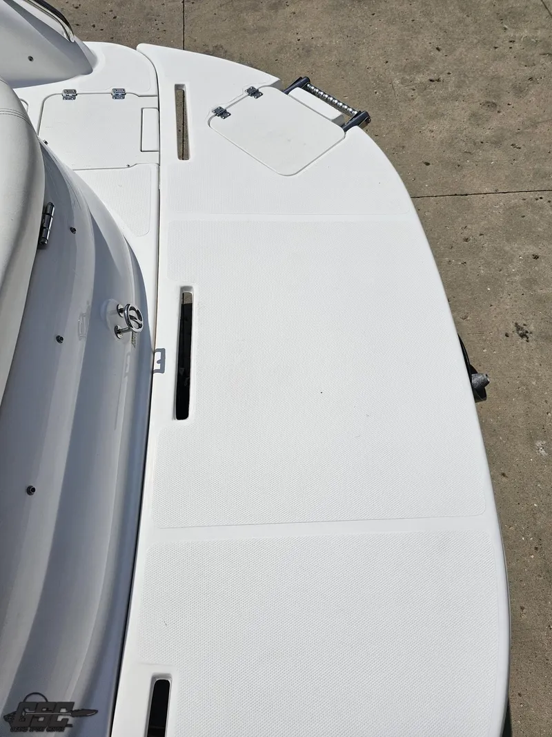 Slide: The Image of 2013 Hurricane SunDeck Sport 202 IO boat deck, white surface, docked on concrete. - 35