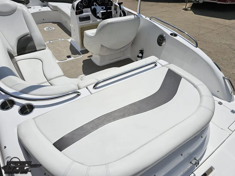 Slide: The Image of 2013 Hurricane SunDeck Sport 202 IO boat interior with white seating and steering console. - 36