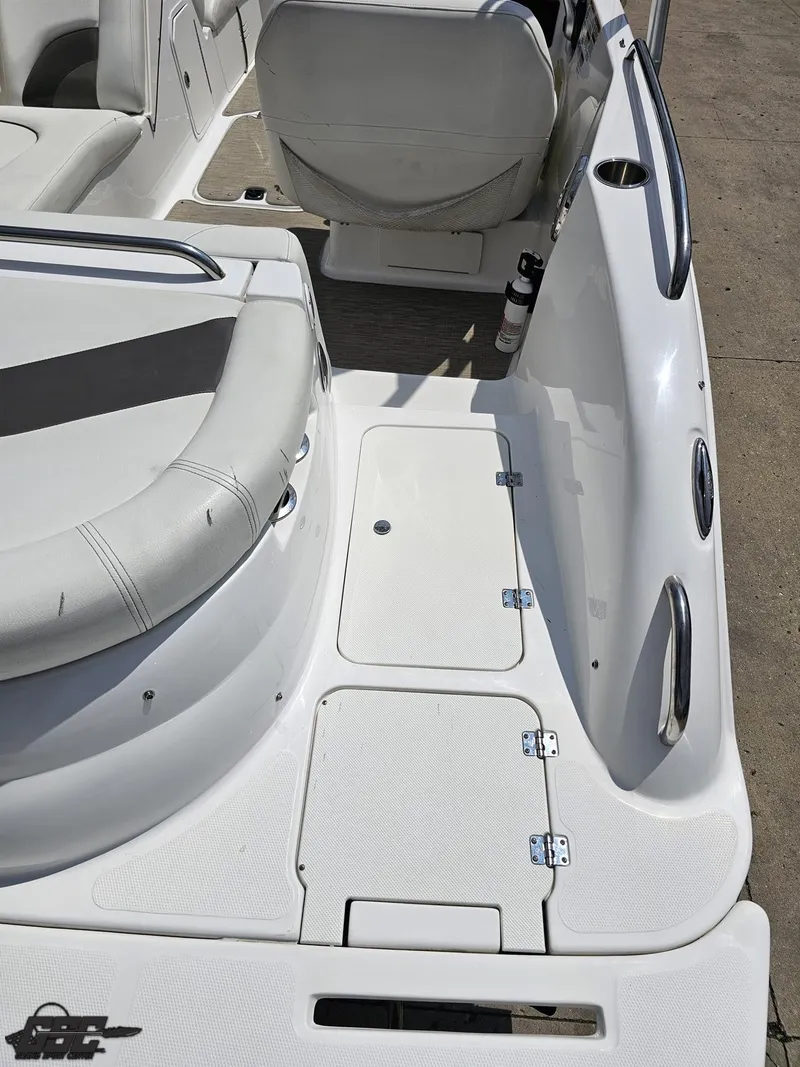 Slide: The Image of 2013 Hurricane SunDeck Sport 202 IO boat interior with white seating and storage compartments. - 39