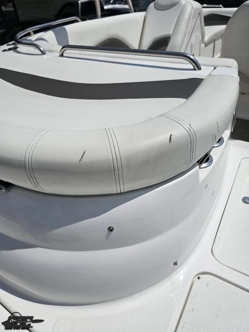 Slide: The Image of 2013 Hurricane SunDeck Sport 202 IO boat seating with white upholstery and metal railings. - 40