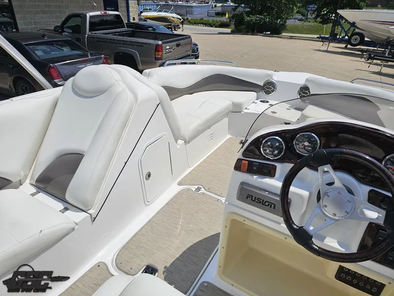 Slide: The Image of 2013 Hurricane SunDeck Sport 202 IO boat interior with steering wheel and seating area. - 44