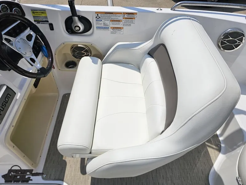 Slide: The Image of 2013 Hurricane SunDeck Sport 202 IO boat interior with white seating and steering wheel. - 49