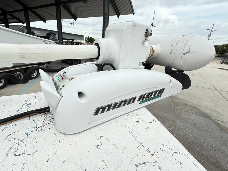 Slide: The Image of Minn Kota Riptide motor on a 2015 Blazer Bay 2400 boat at a marina. - 12