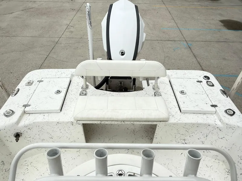 Slide: The Image of 2015 Blazer Bay 2400 boat deck with white seating and storage compartments. - 17