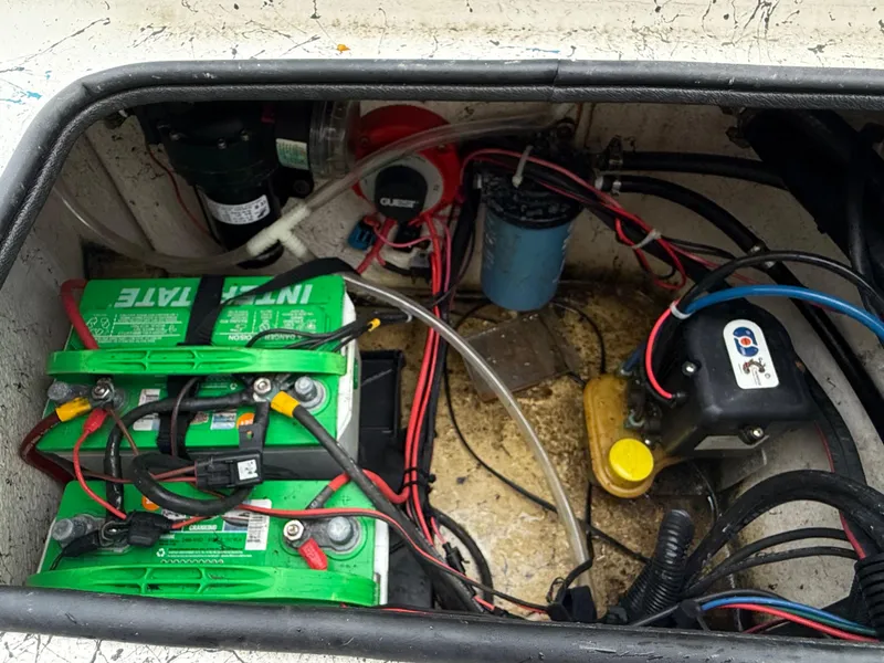 Slide: The Image of Boat battery compartment of a 2015 Blazer Bay 2400 with wiring and components. - 19