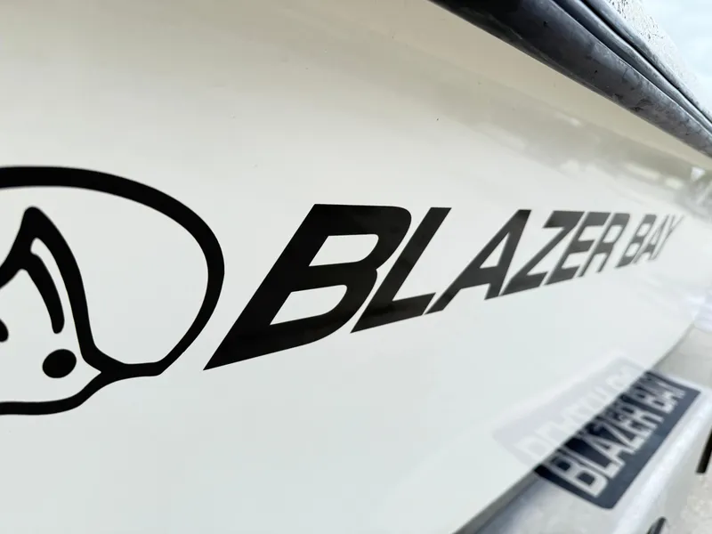Slide: The Image of Close-up of 2015 Blazer Bay 2400 boat logo on white surface. - 6