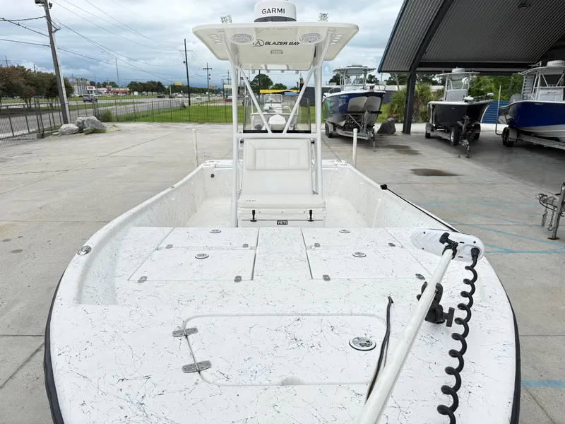 Slide: The Image of 2015 Blazer Bay 2400 boat with Garmin equipment, parked outdoors on concrete. - 7