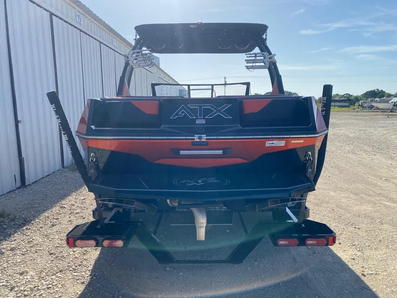 Slide: The Image of 2021 ATX Surf Boats 22 Type-S, rear view, parked outdoors near storage units. - 4