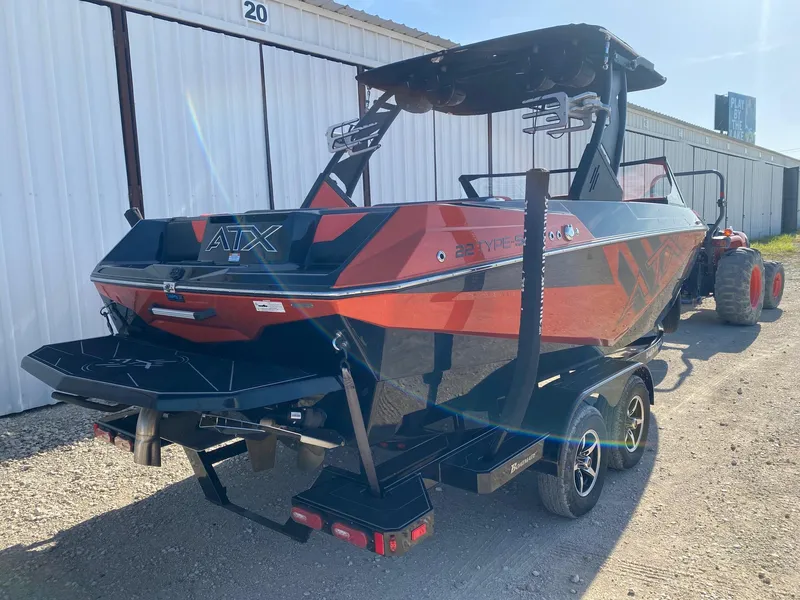 Slide: The Image of 2021 ATX Surf Boats 22 Type-S in vibrant red and black, parked outdoors. - 5
