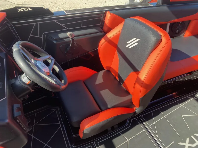 Slide: The Image of 2021 ATX Surf Boats 22 Type-S interior with red and black captain's seat and steering wheel. - 8